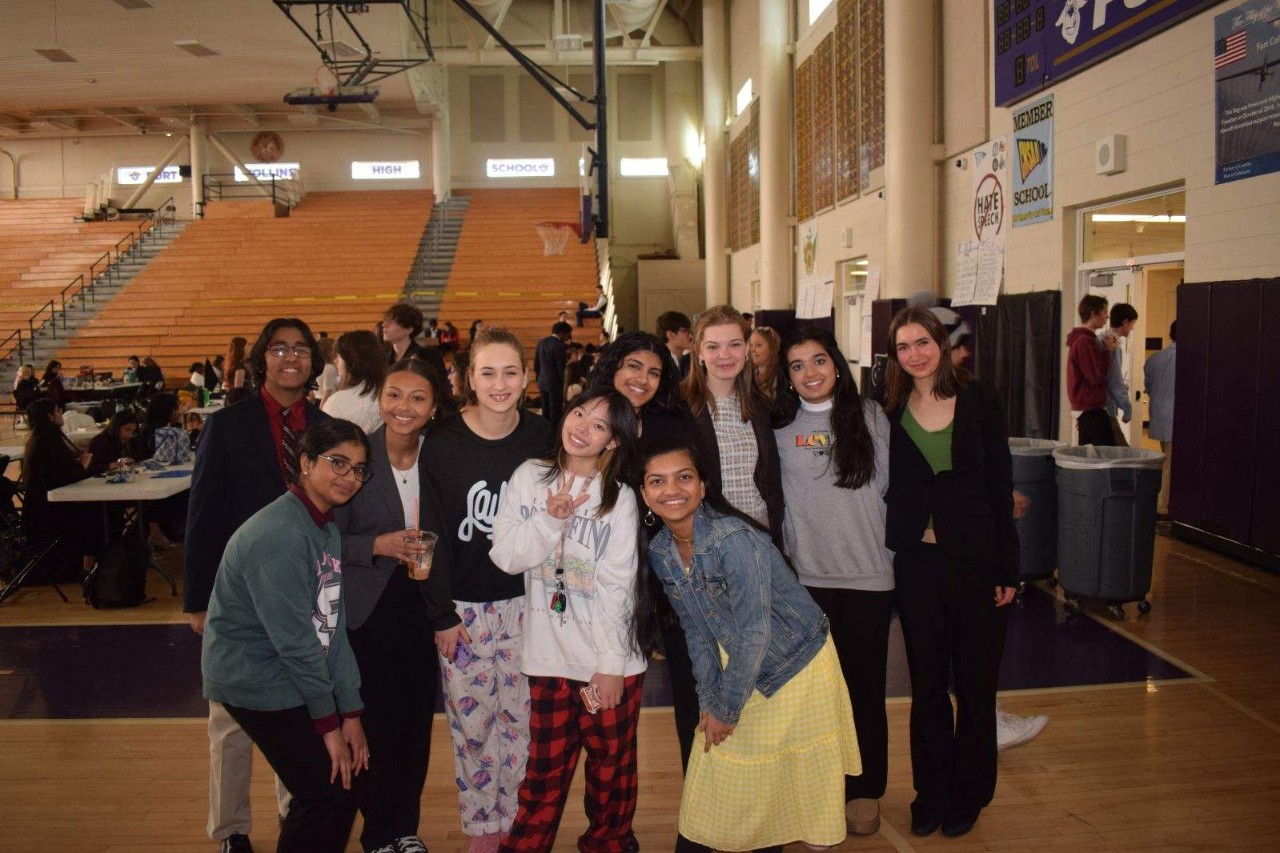 RHS Speech and Debate team poses at their final competition in a high school gym